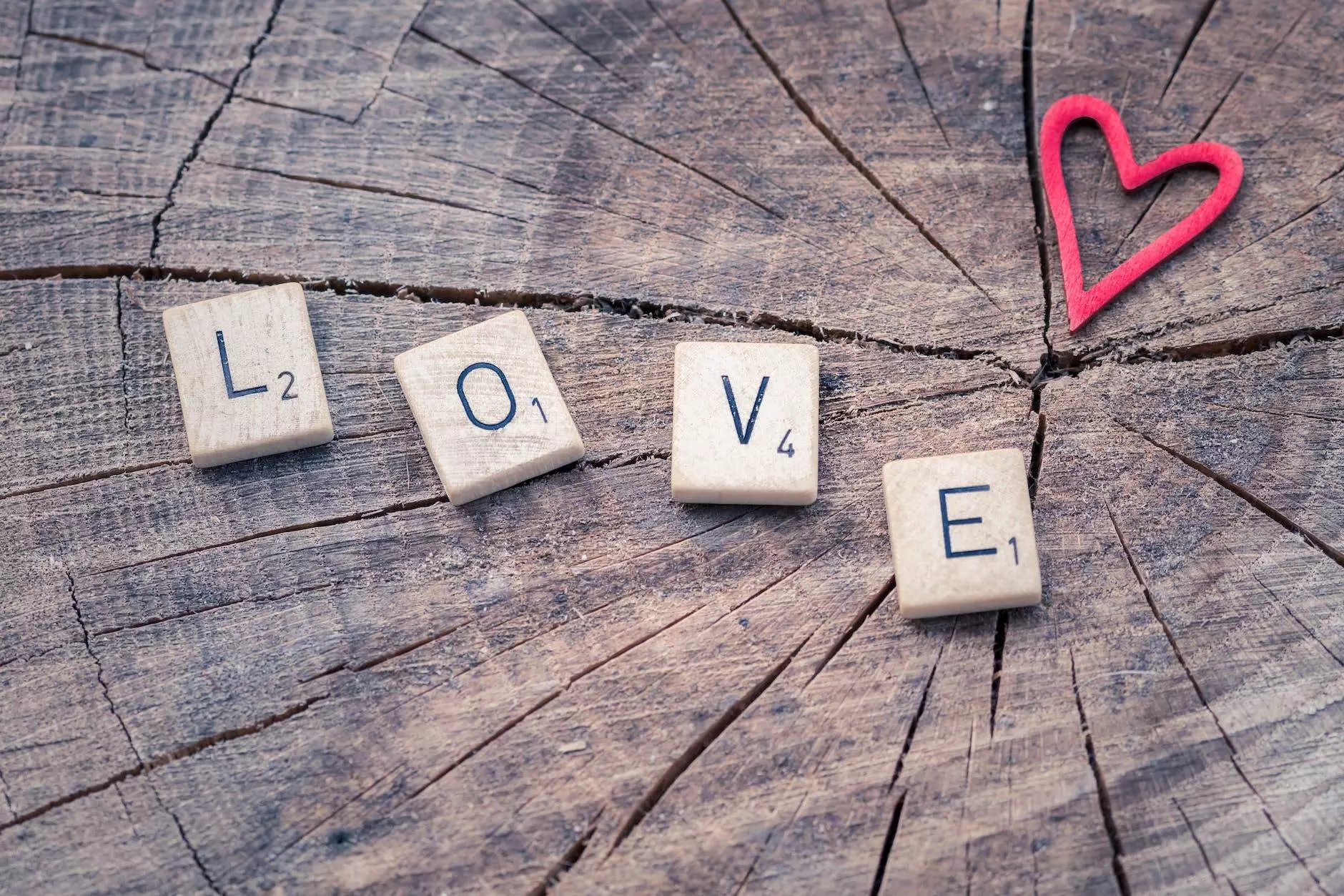 photo of scrabble letter tiles forming the word love