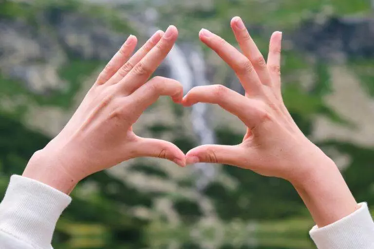 Close up hands forming a heart shape