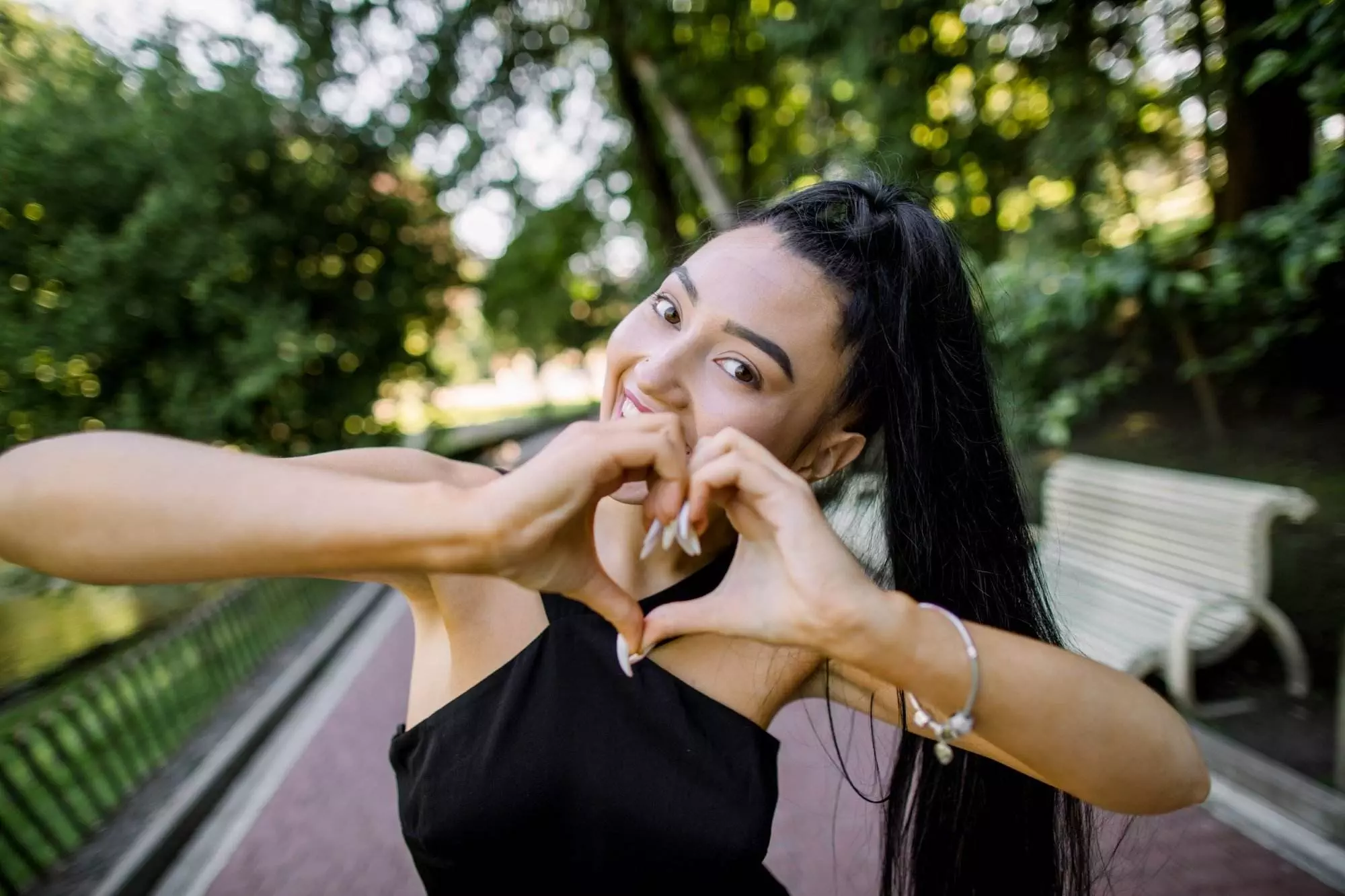 Asian woman making heart shape with hands