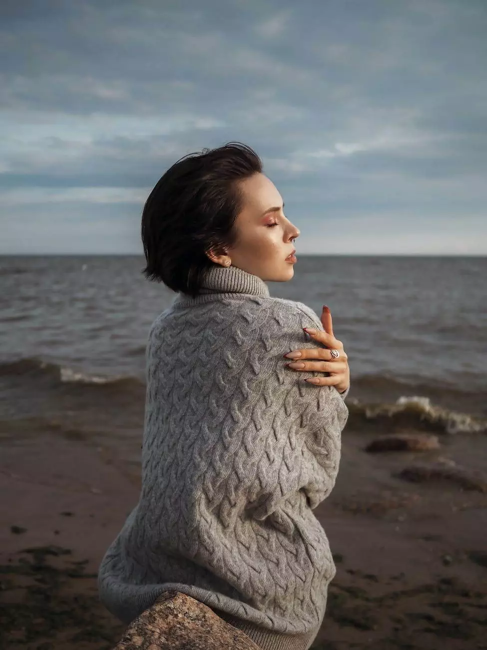 woman hugging herself on a seashore