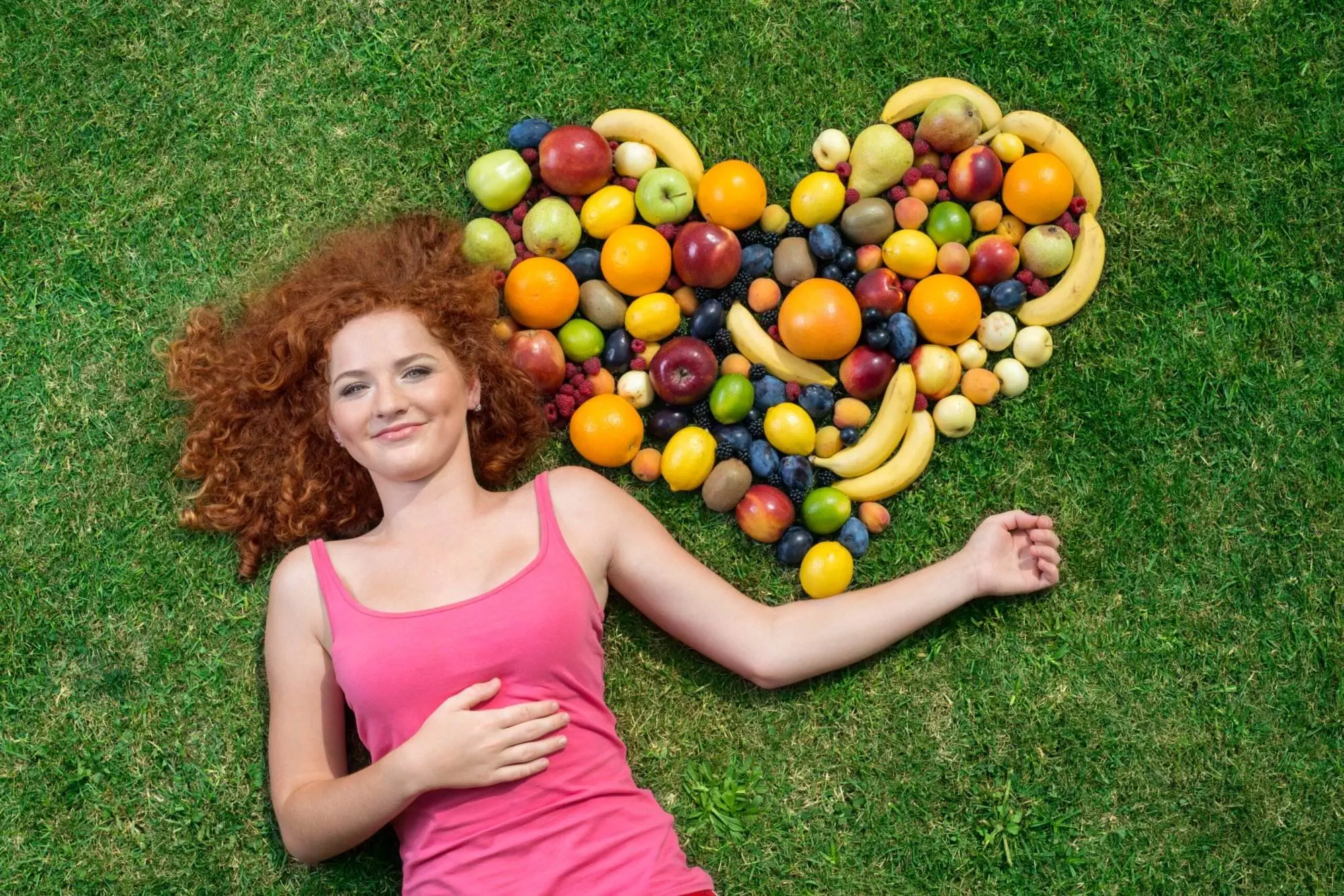 Girl with fruit shaped as heart